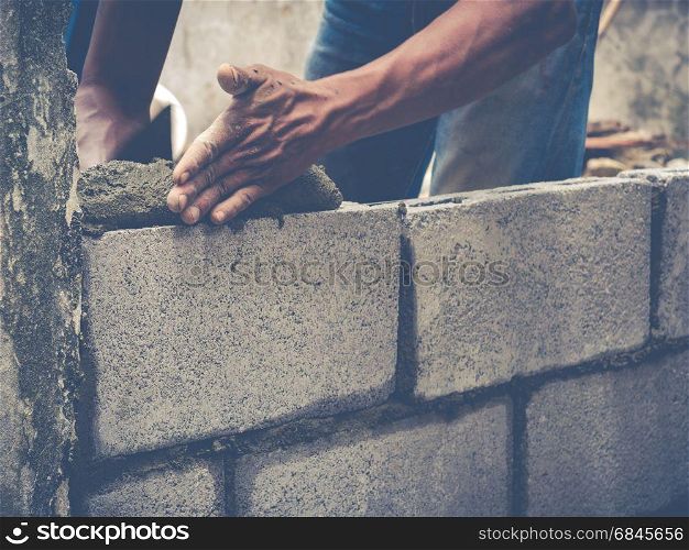 Manson or Brick builders are building walls in Thailand