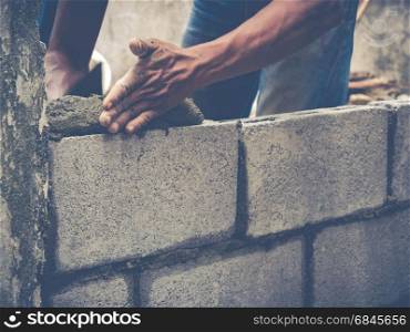 Manson or Brick builders are building walls in Thailand