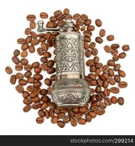 Manual coffee grinder and roasted coffee beans isolated on white background. Top view
