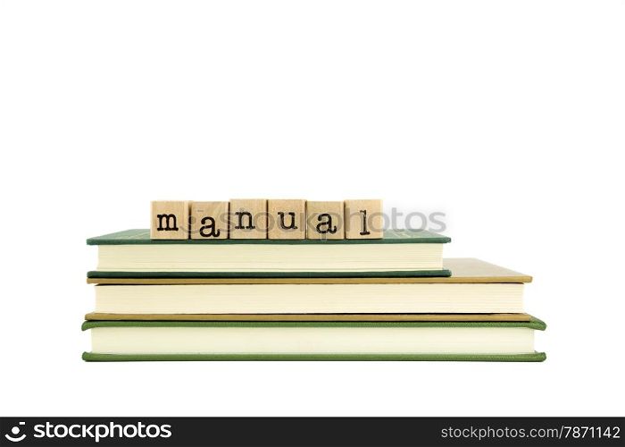 manual word on wood stamps stack on books, textbook and knowledge concept