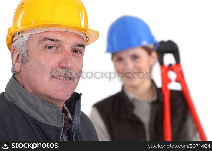 Manual worker and young female assistant