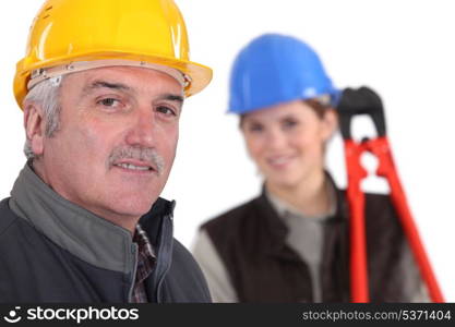 Manual worker and young female assistant