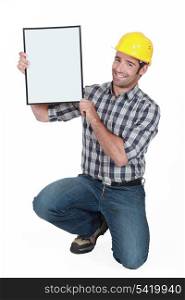 Manual worker holding a blank poster.