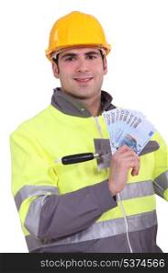 Manual worker holding money