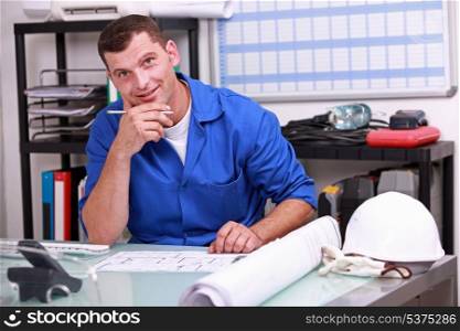 Manual worker looking at paperwork