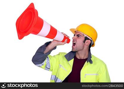 Manual worker shouting through cone