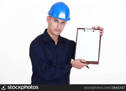 Manual worker stood with clip-board and pen