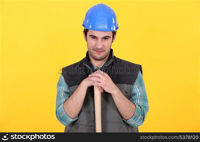 Manual worker stood with large hammer