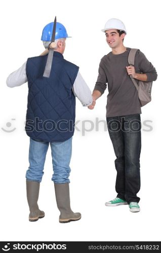 Manual workers shaking hands
