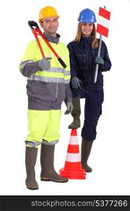 Manual workers stood with traffic cones