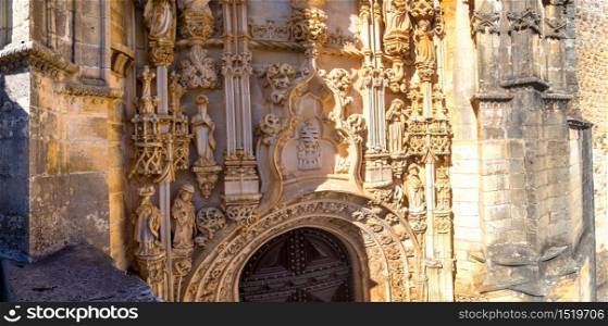 Manueline gate of the Convent of Christ in medieval Templar castle in Tomar in a beautiful summer day, Portugal