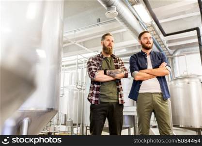 manufacture, business and people concept - men at craft brewery or beer plant. men at craft brewery or beer plant. men at craft brewery or beer plant