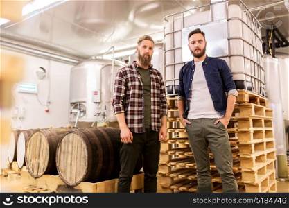 manufacture, business and people concept - men at craft brewery or beer plant. men at craft brewery or beer plant