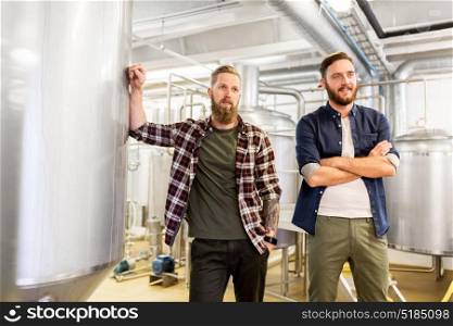 manufacture, business and people concept - men at craft brewery or beer plant. men at craft brewery or beer plant