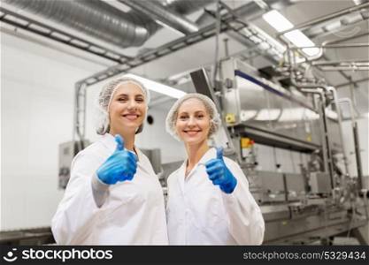 manufacture, industry, gesture and people concept - happy women technologists at ice cream factory shop. happy women technologists at ice cream factory