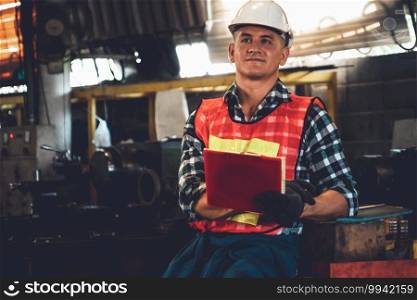 Manufacturing worker working with clipboard to do job procedure checklist . Factory production line occupation quality control concept .