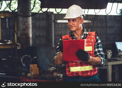 Manufacturing worker working with clipboard to do job procedure checklist . Factory production line occupation quality control concept .