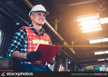 Manufacturing worker working with clipboard to do job procedure checklist . Factory production line occupation quality control concept .. Manufacturing worker working with clipboard to do job procedure checklist .
