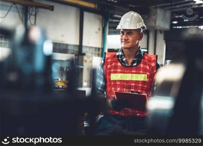 Manufacturing worker working with clipboard to do job procedure checklist . Factory production line occupation quality control concept .. Manufacturing worker working with clipboard to do job procedure checklist .