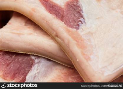 Many big uncooked pieces of lard (bacon) closeup