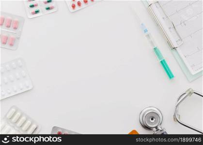 many blister pills pack with syringe stethoscope ecg report clipboard white backdrop. Resolution and high quality beautiful photo. many blister pills pack with syringe stethoscope ecg report clipboard white backdrop. High quality beautiful photo concept