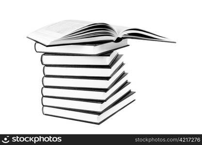 Many books in pile and white isolated background black and white photo.