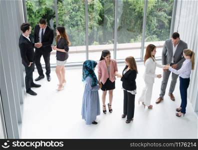 Many business people gathering in modern office building for business conference in the city. Businessmen and businesswomen communication and human resources concept.