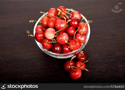 many cherries in a glass at a table