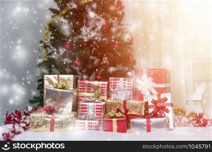 Many Christmas presents gift boxes on a table with Christmas tree, holidays, presents, new year and celebration concept