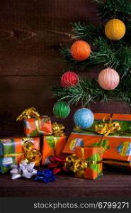 Many Christmas presents under the tree and decorations on plank background. Many Christmas presents under the tree and decorations