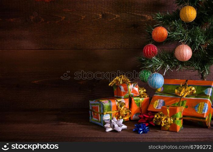 Many Christmas presents under the tree. Many Christmas presents under the tree on plank background