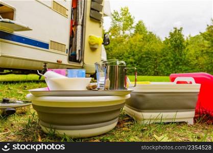 Many clean dishes drying outdoor against c&er vehicle. Washing up on fresh air. C&ing on nature, dishwashing outside.. Clean dishes drying on fresh air, c&ing outdoor