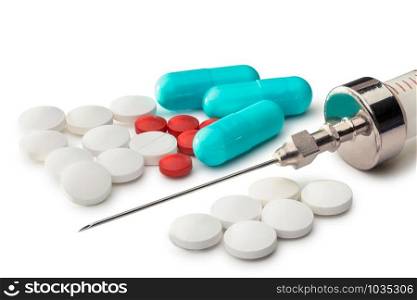 Many colored pils, tablets and capsuls for pharmacy and medicine, with a syringe