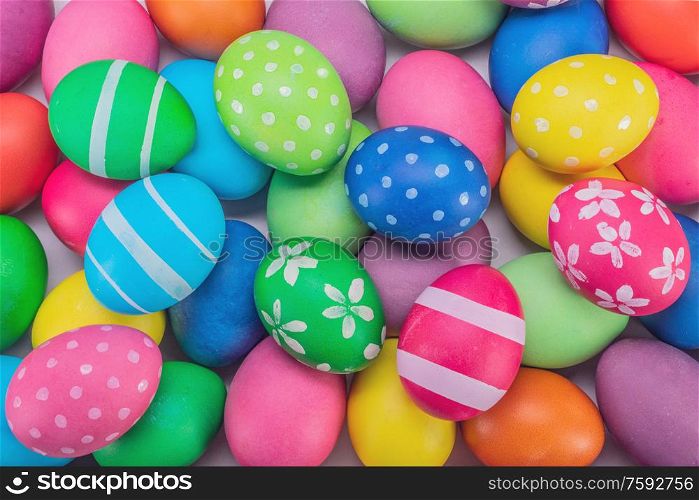 Many colorful decorated painted easter eggs multicolored close up background top view. Easter eggs multicolored background