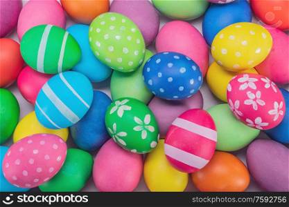 Many colorful decorated painted easter eggs multicolored close up background top view. Easter eggs multicolored background