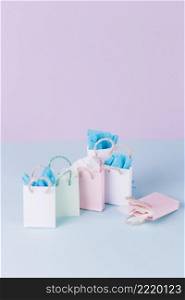 many colorful paper shopping bags blue surface