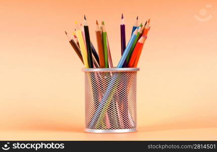 Many colorful pencils on the color background