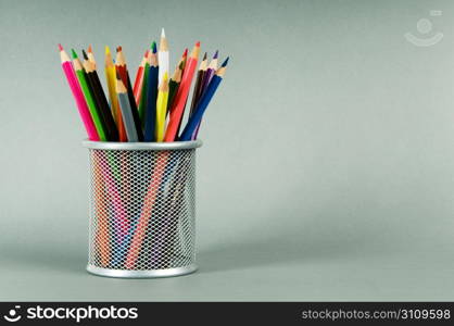 Many colorful pencils on the color background