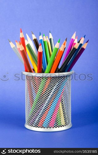 Many colorful pencils on the color background