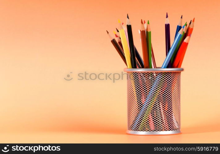 Many colorful pencils on the color background