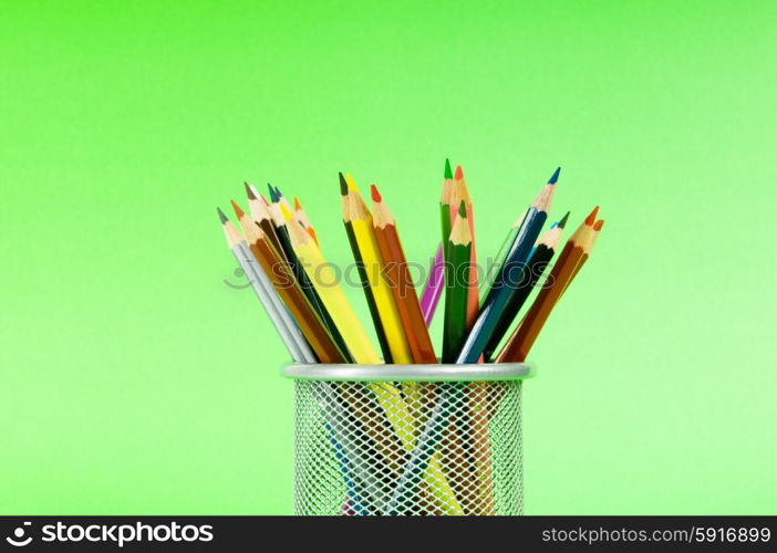 Many colorful pencils on the color background