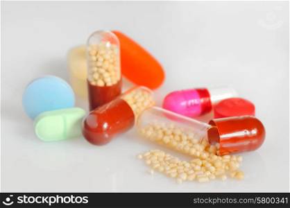 Many colorful pills isolated on white