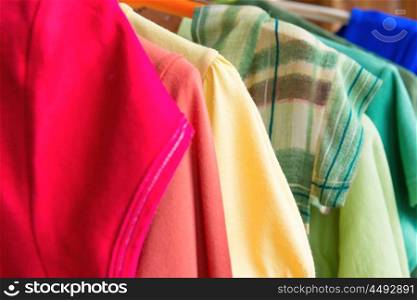 Many colorful shirts on the clothes retail sale
