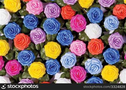 many-coloured plastics roses on a table