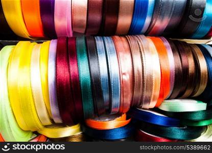 many-coloured ribbon spools in the craft