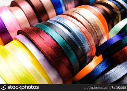 many-coloured ribbon spools in the craft