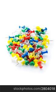 Many colourful office pins isolated on the white