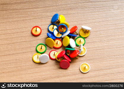 Many colourful office pins on the background