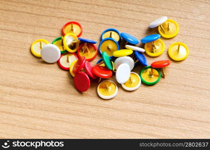 Many colourful office pins on the background