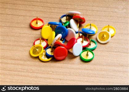 Many colourful office pins on the background